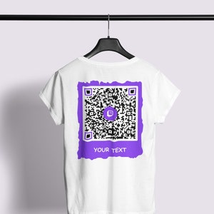 May include: White t-shirt with a purple and black Twitch QR code on the back. The QR code has a purple border and the text "YOUR TEXT" underneath.