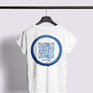May include: White t-shirt with a blue circle containing a QR code and the text "YOUR TEXT" printed on the back.