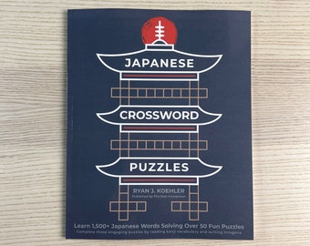May include: A blue book cover featuring a white illustration of a Japanese pagoda. The book title is "Japanese Crossword Puzzles" and the author is "Ryan J. Koehler". The book cover also includes the text "Learn 1,500+ Japanese Words Solving Over 50 Fun Puzzles".