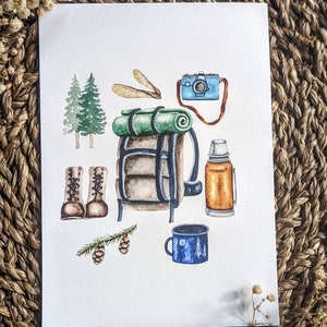 Op de afbeelding: Een aquarel-illustratie van kampeeruitrusting, waaronder een groen-bruine rugzak, een blauwe thermosfles, een blauwe mok met een maan- en boomontwerp, een paar bruine wandelschoenen, een blauwe camera en een groene slaapzak.