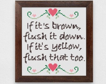 May include: Cross-stitch embroidery in a brown frame with a white background. The embroidery reads "If it's brown, flush it down. If it's yellow, flush that too." with two pink hearts at the top and bottom.