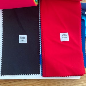 May include: Two fabric swatches, one black with the code "9240 nero" and one red with the code "4186 redcoat".