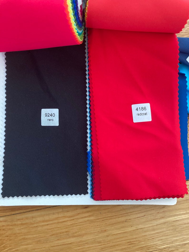 May include: Two fabric swatches, one black with the code "9240 nero" and one red with the code "4186 redcoat".