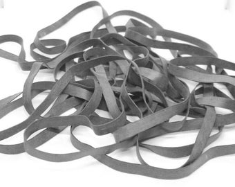 May include: A pile of black rubber bands.
