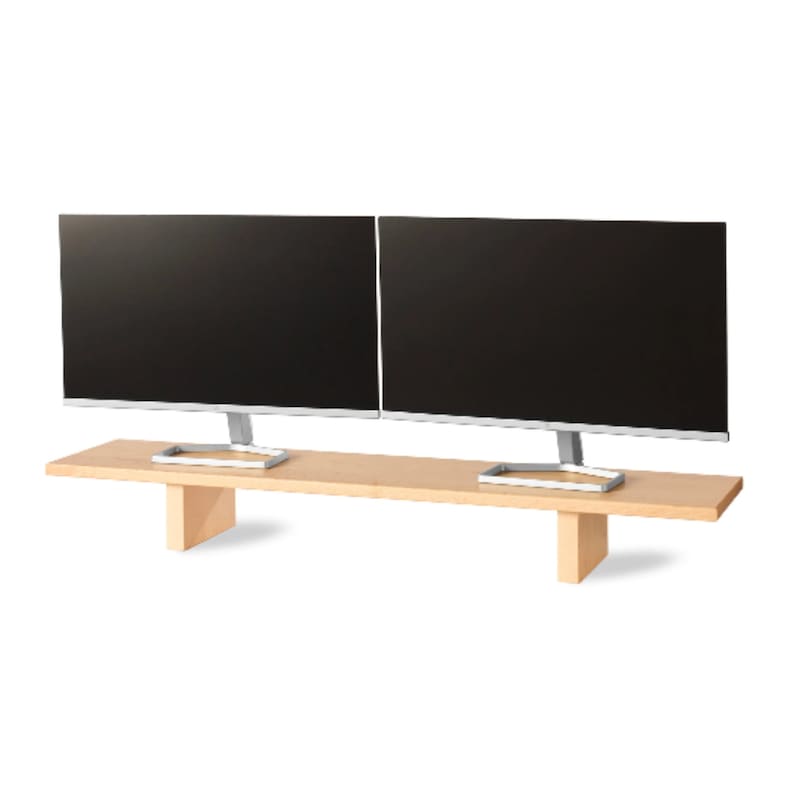 May include: Two black computer monitors with silver stands are placed on a light brown wooden monitor stand. The stand has a rectangular shape with two supporting legs. The monitors are side by side.