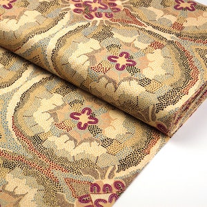 May include: Beige fabric with a repeating pattern of brown, red, and blue stylised flowers. The fabric is folded in half and the pattern is visible on both sides.