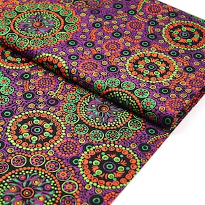 May include: A folded fabric with a repeating circular pattern. The design features concentric circles in shades of purple, black, orange, and green. The fabric has a detailed, dotted texture, creating a vibrant and eye-catching textile.