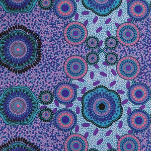 May include: A blue and purple fabric with a repeating pattern of circles and dots. The circles are surrounded by smaller dots and have a pink centre. The fabric has a light blue background.