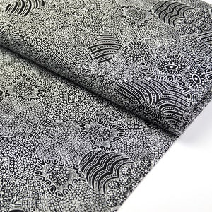 May include: Black fabric with a white patterned design featuring abstract shapes and dots. The fabric is folded in half, showing the pattern on both sides.