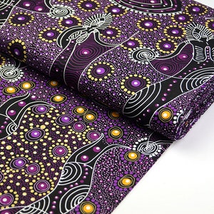 May include: Purple and gold fabric with an Aboriginal-inspired design featuring dots, circles, and wavy lines. The fabric is folded in half, showing the pattern on both sides.