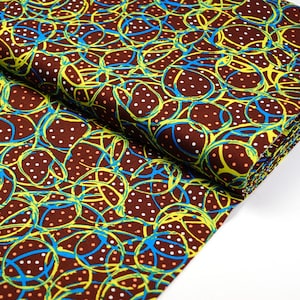 May include: Brown fabric with a repeating pattern of yellow, blue and white circles and lines.