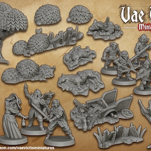 Puede incluir: Una colección de figuras y piezas de escenografía en miniatura, que incluyen un árbol, arbustos, un carro, un caballo muerto y varios goblins. Las figuras están hechas de plástico gris y no están pintadas. El texto "Vae Victis Miniatures" es visible en la esquina superior derecha de la imagen.