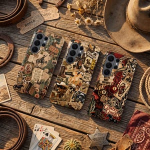 May include: Three phone cases with a Western theme, featuring cowboy imagery, text, and vintage designs. The cases are brown, beige, and red, with images of cowboys, horses, and other Western elements. The cases are arranged on a wooden surface.