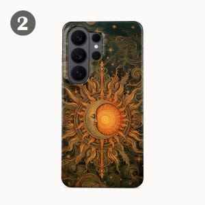 May include: A rectangular smartphone case featuring a detailed illustration of a crescent moon with a human face overlapping a radiant sun. The design includes intricate golden swirls, star patterns, and dark green textures throughout the surface.