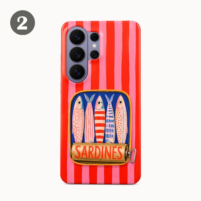 May include: A phone case with a red and pink striped background. The case features a rectangular graphic of a sardine can with five colorful fish. The word "SARDINES" is printed on the can.