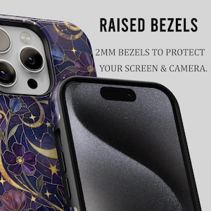 May include: A smartphone case with a celestial design featuring gold accents, purple flowers, and stars on a dark blue background. The text "RAISED BEZELS" and "2MM BEZELS TO PROTECT YOUR SCREEN & CAMERA" is displayed.