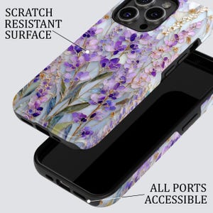 May include: A phone case with a floral design featuring purple and white flowers on a light blue background. The case is black and has the text "SCRATCH RESISTANT SURFACE" and "ALL PORTS ACCESSIBLE".