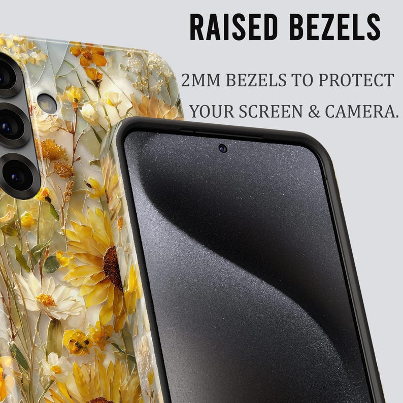 May include: A smartphone case with a floral design featuring yellow sunflowers and white flowers. The case has raised bezels to protect the screen and camera. The text on the image reads "RAISED BEZELS" and "2MM BEZELS TO PROTECT YOUR SCREEN & CAMERA."