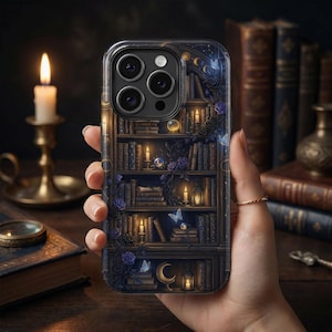 May include: A phone case featuring a detailed bookshelf design with books, candles, and floral accents. The case has a dark, gothic aesthetic with a touch of fantasy. The design includes moons, butterflies, and roses, creating a mystical vibe.