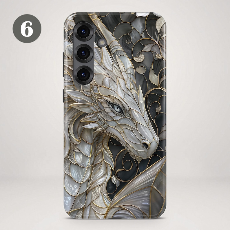 May include: A rectangular smartphone case featuring a detailed illustration of a white dragon with iridescent scales and gold outlines. The background consists of dark, swirling patterns. The number 6 is visible in the upper left corner.