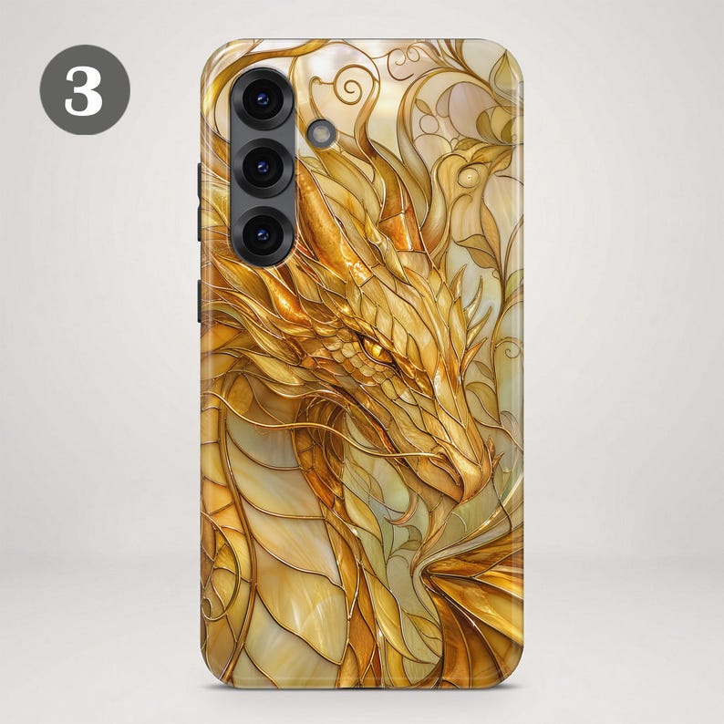 May include: A smartphone case featuring a golden dragon illustration with intricate, stained-glass style line work and layered scales. The design incorporates flowing, organic shapes in shades of yellow, amber, and gold, with a prominent number 3 visible.