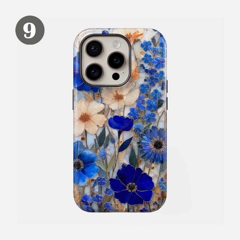 May include: A floral phone case featuring a vibrant design of blue and cream-colored flowers. The case has a glossy finish and a camera cutout. The design includes various flower types and green leaves against a light background.