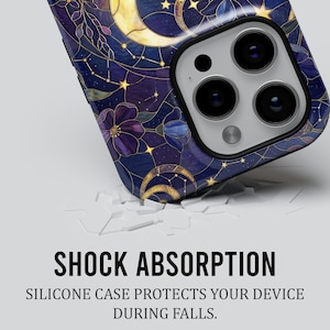 May include: A phone case with a celestial design is shown. The case has a dark blue background with gold crescent moons, stars, and purple floral accents. The text "SHOCK ABSORPTION" is displayed in bold black letters.
