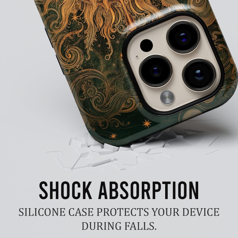 May include: A smartphone case featuring a dark green background with intricate gold sun and swirl patterns. The text SHOCK ABSORPTION and SILICONE CASE PROTECTS YOUR DEVICE DURING FALLS is printed below the case, which has a triple camera lens.