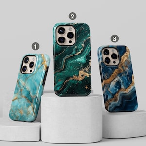 May include: Three iPhone cases with a marble design. The cases are green, blue, and turquoise with gold accents.