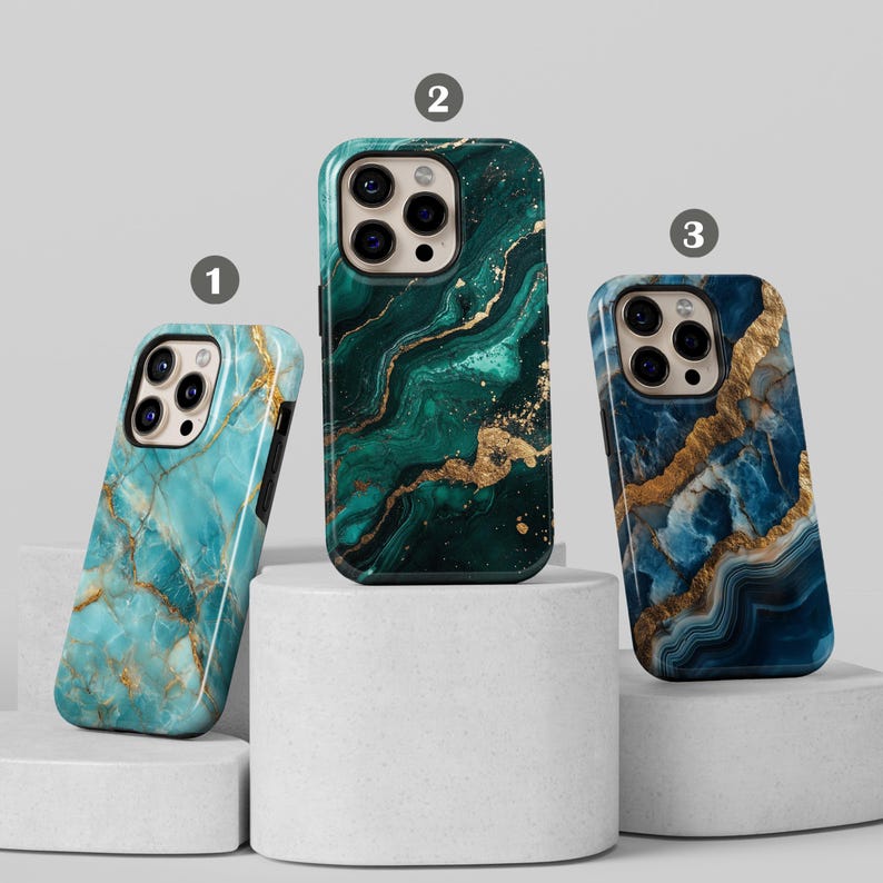 May include: Three iPhone cases with a marble design. The cases are green, blue, and turquoise with gold accents.