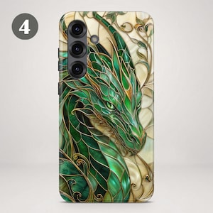 May include: A smartphone case featuring a stained glass style illustration of a green dragon with gold outlines. The dragon has detailed scales and piercing green eyes, set against a cream-coloured background with swirling gold vine patterns.