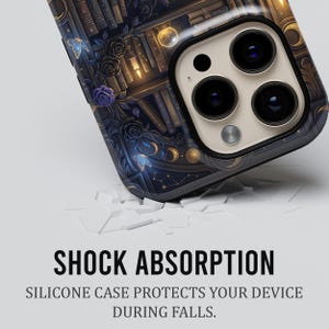 May include: A smartphone case with a detailed design featuring a bookshelf, butterflies, roses, and celestial elements in shades of blue, gold, and purple. The case has a glossy finish and the text "SHOCK ABSORPTION" is visible.