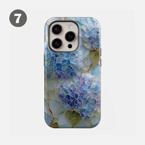 May include: A phone case featuring a floral design with blue and purple hydrangea flowers. The case has a glossy finish and a black camera lens area. The flowers have gold-colored outlines and green leaves.