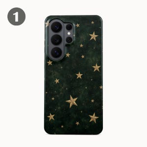 May include: A dark green smartphone case featuring a scattered pattern of gold-colored stars of varying sizes. The case has a cutout for a multi-lens camera system in the upper left corner and a smooth, dark, mottled background texture.