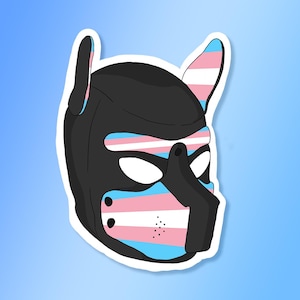 May include: A sticker featuring a black pup hood with the transgender pride flag colors. The design includes pink, white, and light blue stripes across the muzzle and ears, set against a gradient blue background.