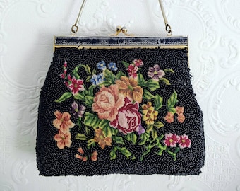 May include: A black beaded evening bag with a floral design and a silver chain strap.