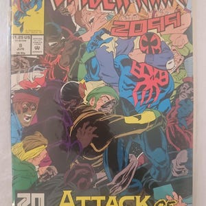 May include: A comic book cover featuring Spider-Man 2099 in a blue and red suit with a black spider symbol on his chest. The cover is titled "Attack of the Freakers" and features a group of people in the background.