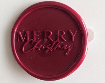May include: A red wax seal with the words "Merry Christmas" embossed in white.