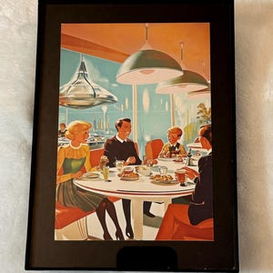 May include: A framed retro-style print depicting a restaurant scene. The artwork features a group of people seated around a white table, enjoying food and drinks. The color palette includes orange, red, and teal, with stylized lighting fixtures.