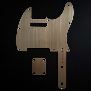 May include: A set of three brushed aluminium guitar parts, including a body, a pickguard, and a control plate.