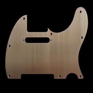 May include: A brushed metal guitar pickguard with a rectangular cutout for the pickups and several screw holes. The pickguard has a curved shape and a metallic finish, likely for an electric guitar.