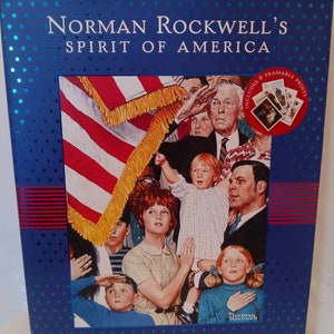 May include: A blue book cover with a painting of people saluting the American flag. The book title is "Norman Rockwell's Spirit of America: A Family Treasury".