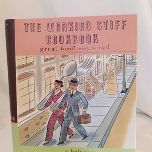 May include: The cover of a cookbook titled "The Working Stiff Cookbook: great food! easy recipes!"  The cover features a cartoon illustration of a man and woman walking down a city street. They are carrying a large spoon and fork on their shoulders. The illustration is in a retro style.