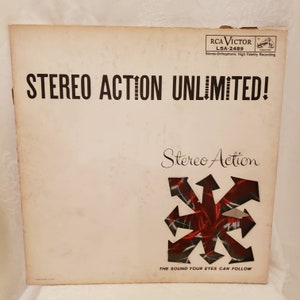 May include: A vintage vinyl record album cover with the title "Stereo Action Unlimited!" in bold black letters. The cover features a red, black, and white graphic of a stylized starburst with the text "Stereo Action" in cursive script. The album is by RCA Victor and has the catalog number LSA-2489.