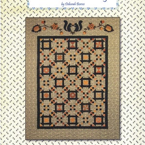 May include: Quilt pattern titled "Peanut Butter & Honey" by Deborah Borso. The quilt features a brown, black, and orange color scheme with a geometric design. The pattern is from Painted Pony 'n Quilts.