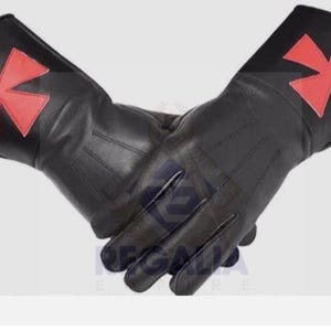 May include: A pair of black leather gloves with a red Maltese cross emblem on the back of each hand. The gloves are made of a smooth, shiny leather and appear to be new. The gloves are designed for protection and style.