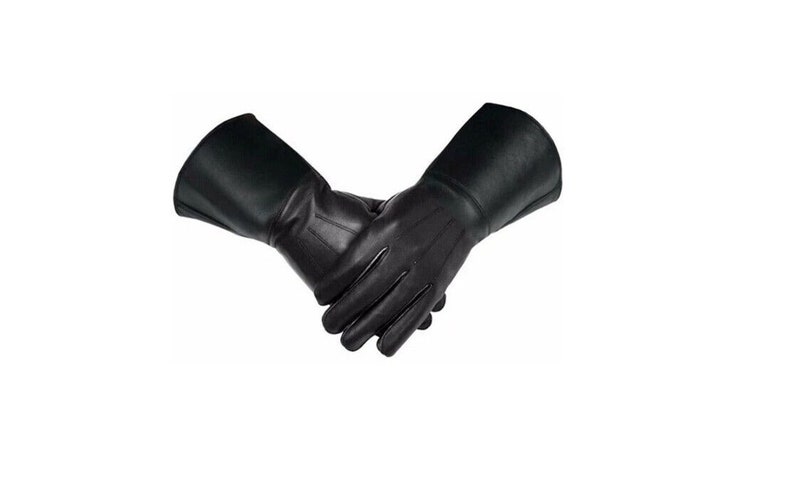 May include: A pair of black leather gloves with long cuffs. The gloves are folded in half with the fingertips touching.