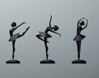 May include: Three black ballerina figurines in a variety of poses. Each figurine is made of geometric shapes and is standing on a black base.