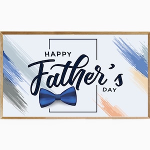 May include: A rectangular wooden framed print with the words "Happy Father's Day" in a stylish script font. A blue bow tie graphic is featured below the text. The background has blue, grey, and orange brushstrokes.