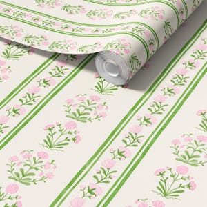 May include: White wallpaper with green stripes and pink floral designs. The wallpaper is rolled up and the end of the roll is visible.
